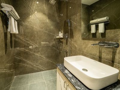 Guest bathroom with walk-in shower at Emerald Signature, Mysuru