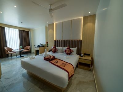 Guest room with king bed at Emerald Signature, Mysuru