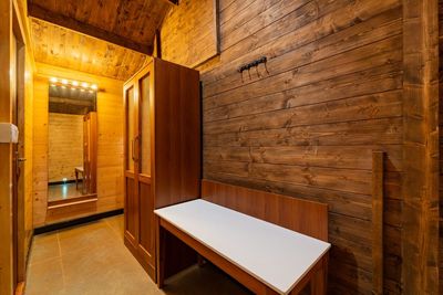Wooden wardrobe and dressing area inside a cottage at Miraya by the Beach